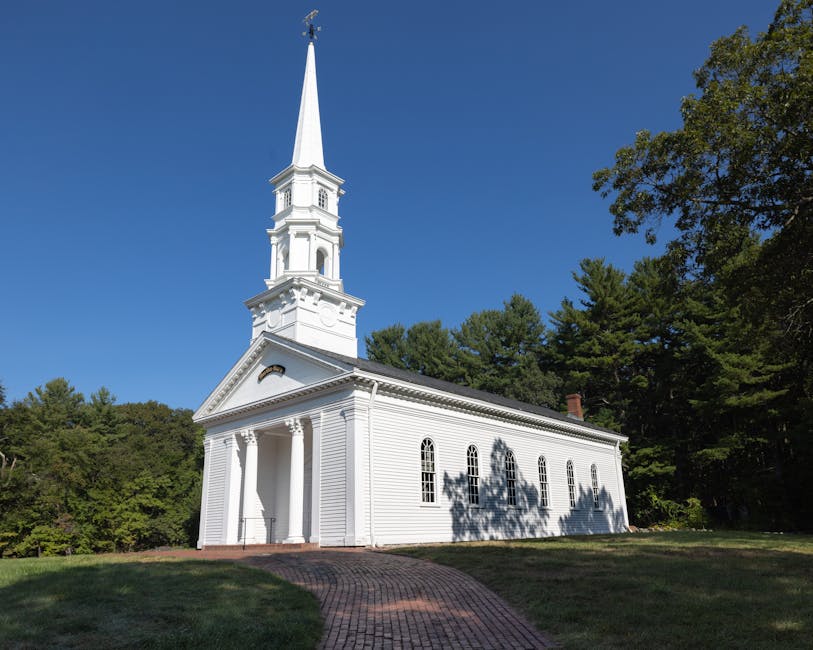 Charming white church with steeple surrounded by trees in Sudbury, Massachusetts.